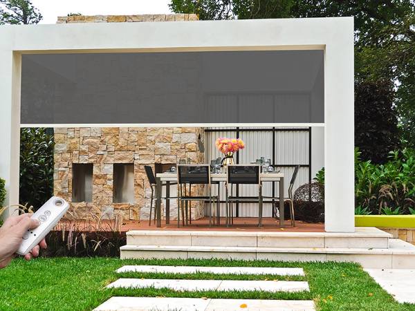 Retractable patio sunshade is made of fiberglass screen.